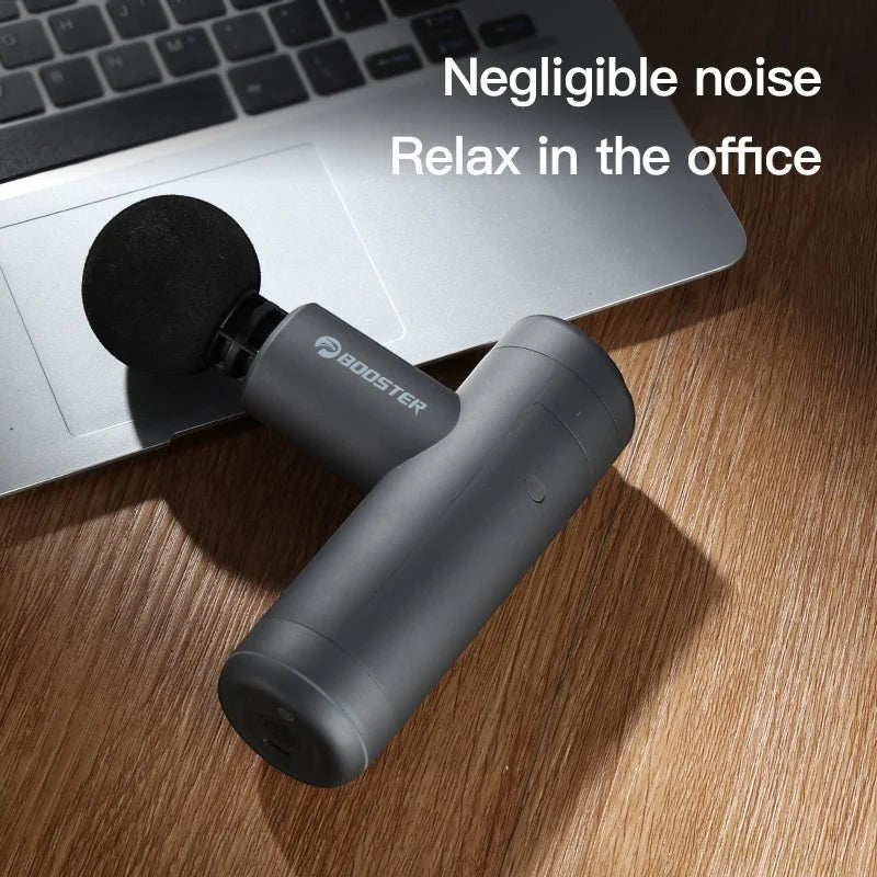 Relief Motion portable grey massage gun with a round foam head, ergonomic design, and USB-C charging for muscle relief.
