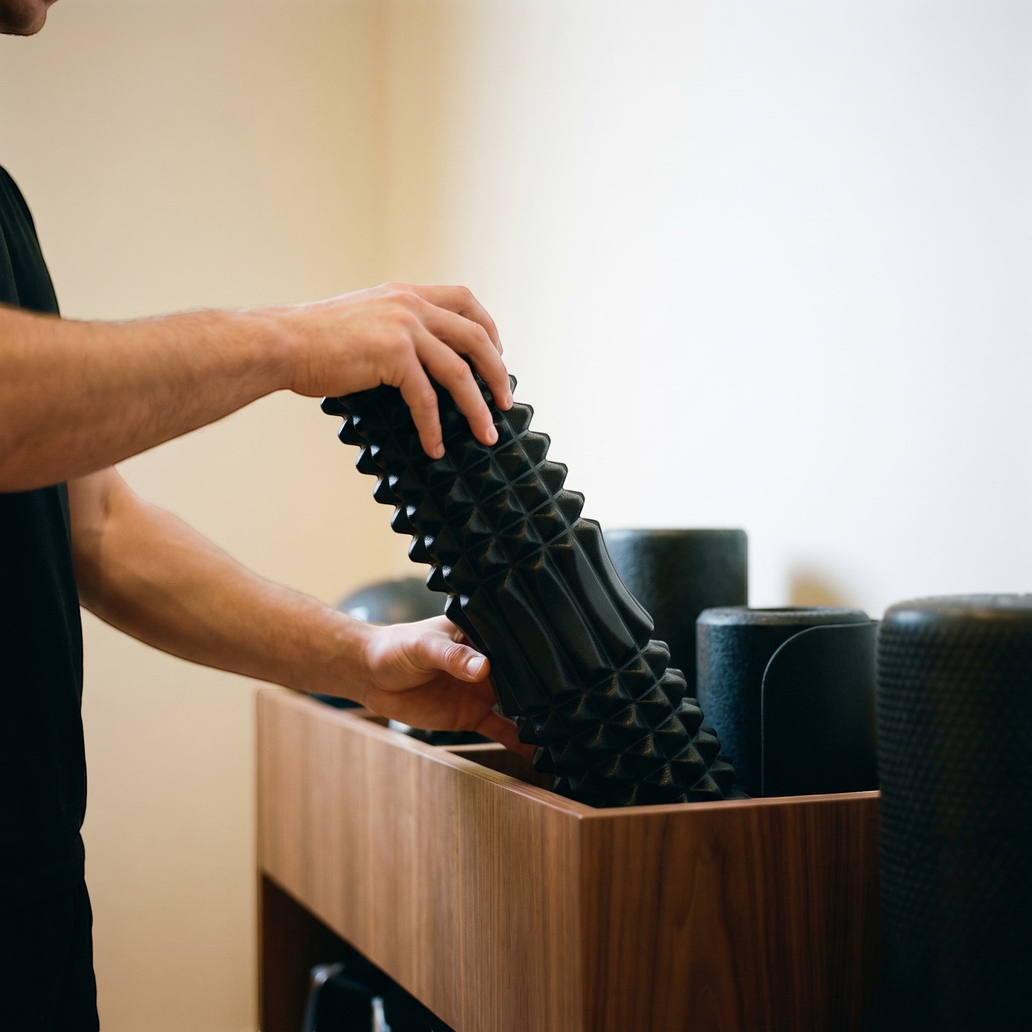 Relief Motion black deep tissue massage foam roller with textured surface for muscle relief and flexibility.